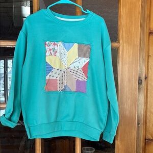 Teal Patchwork Women's upcycled sweatshirt with and antique quilt square